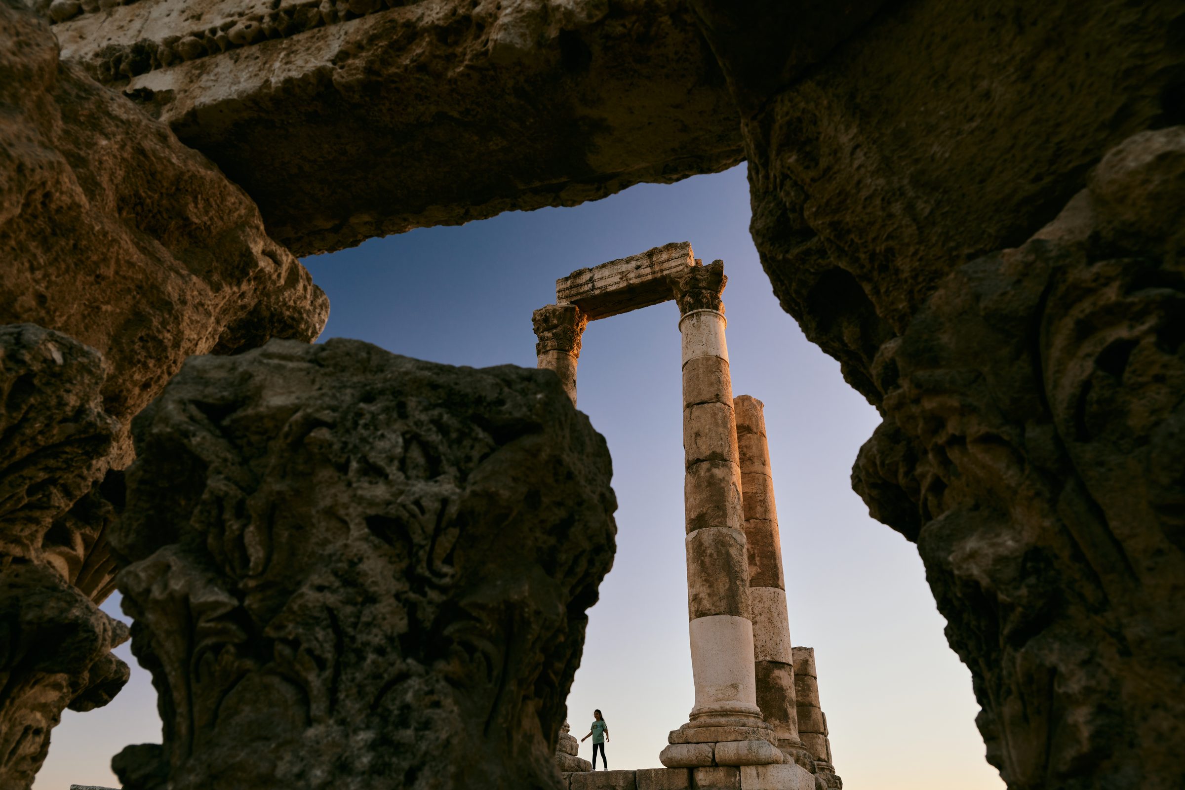 Rock cave opening framing ancient columns