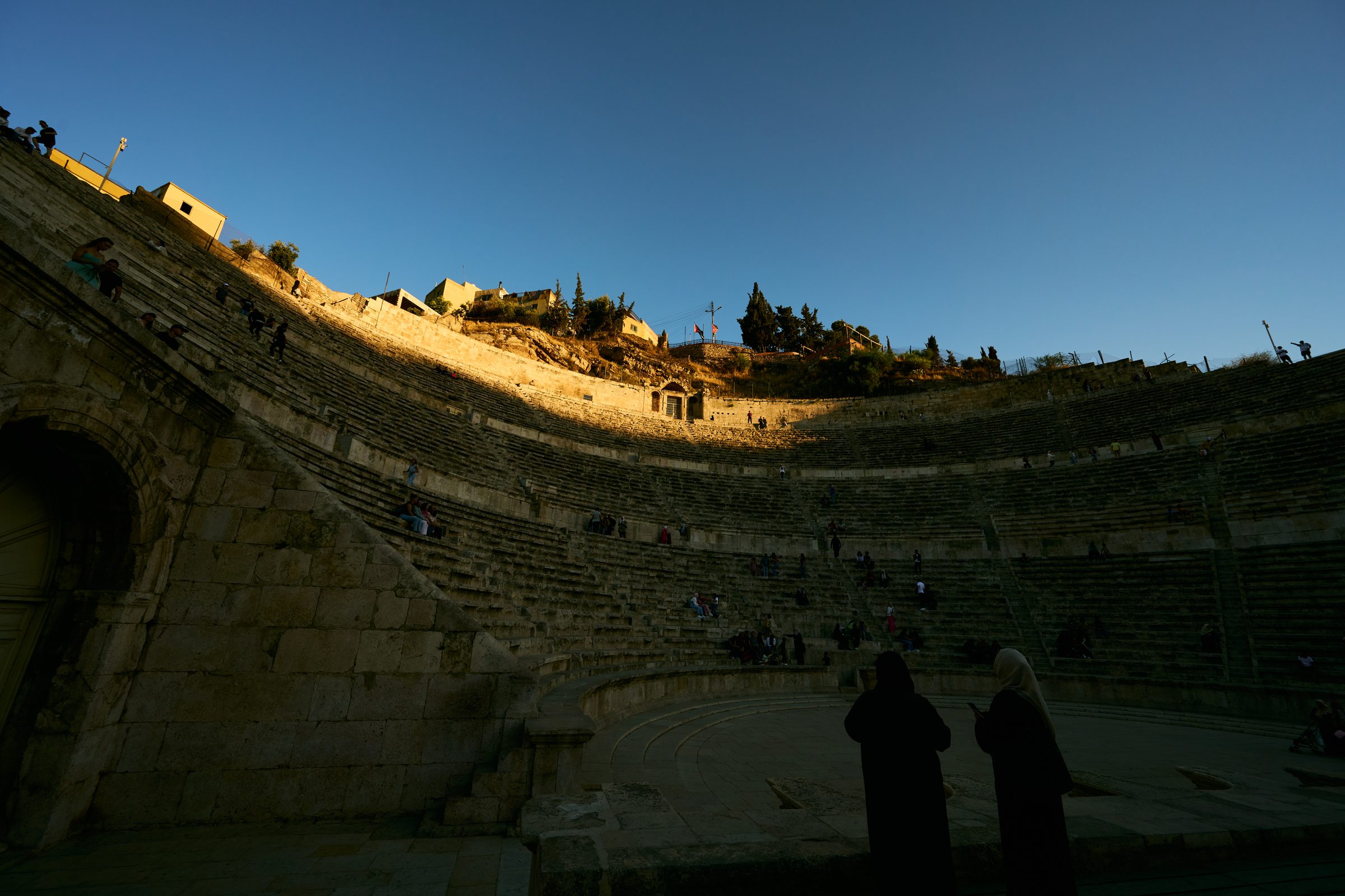 Ancient theatre at dusk with two figures