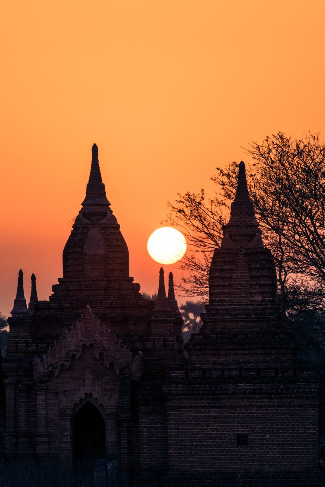 Temple spires in silhouette against the sunset sky, Bagan, Myanmar