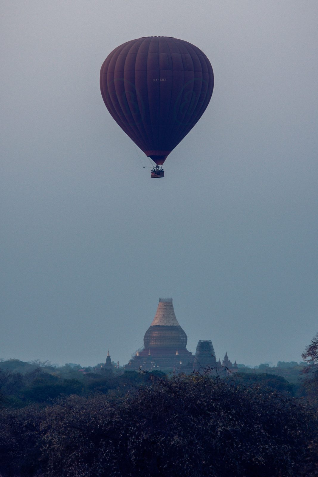 Hot-air balloon drifting over a distant pagoda, Bagan, Myanmar