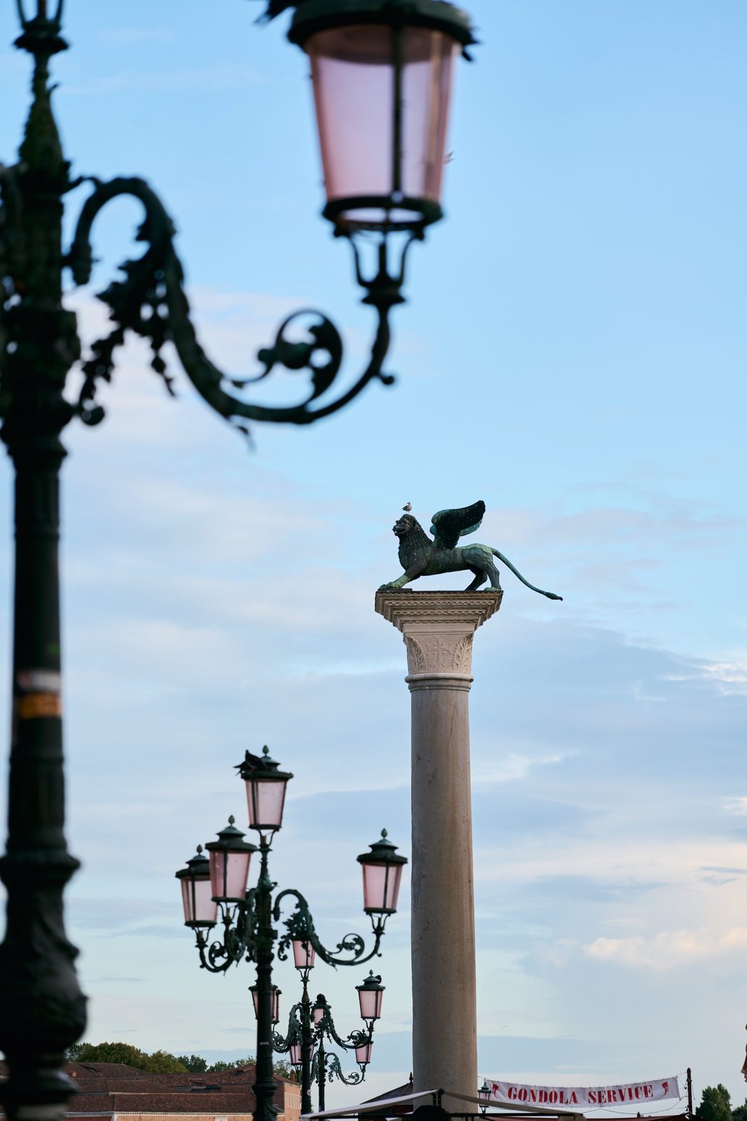 Ornate lamp posts and the column of the Lion of Saint Mark at the Piazzetta, Venice