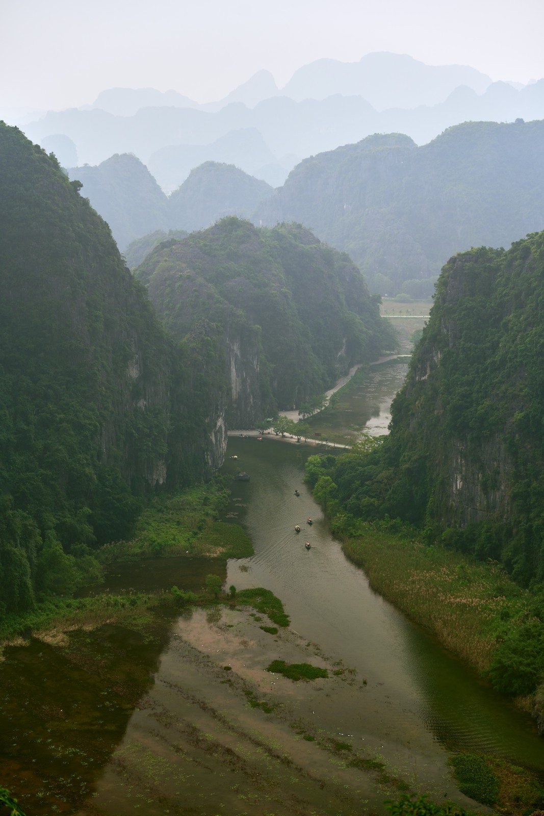 River gorge seen from above with boats between karst peaks, Ninh Binh, Vietnam