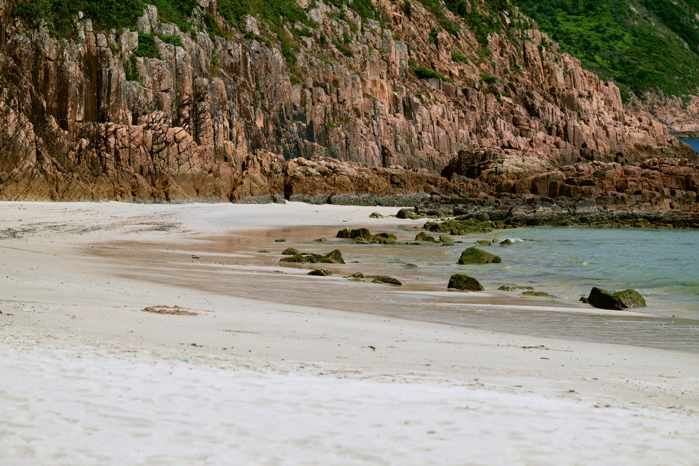 Rock columns above a white sand beach, MacLehose Trail, Sai Kung, Hong Kong