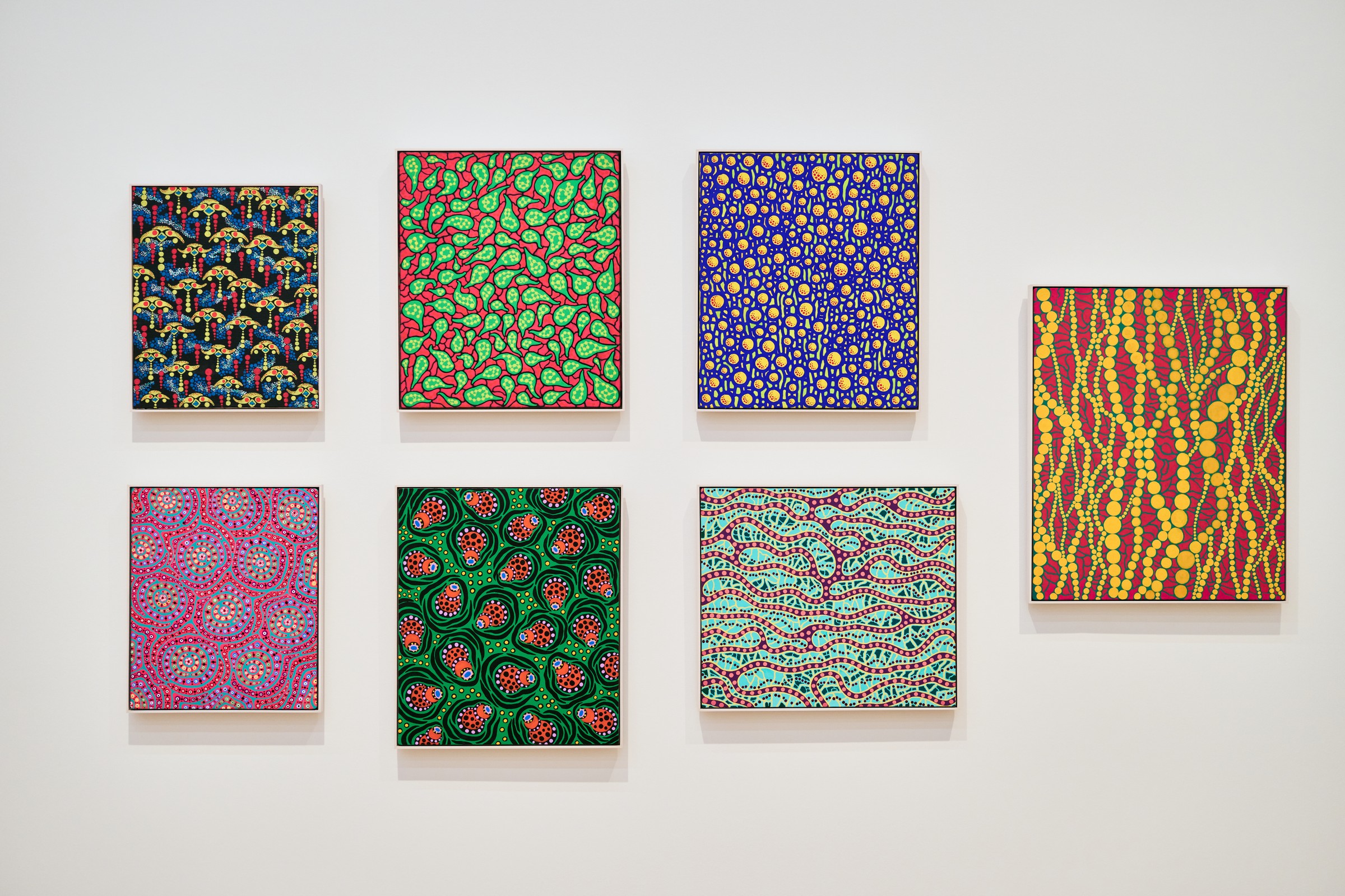 Seven small patterned paintings hung on a white wall, Yayoi Kusama, Stedelijk Museum Amsterdam