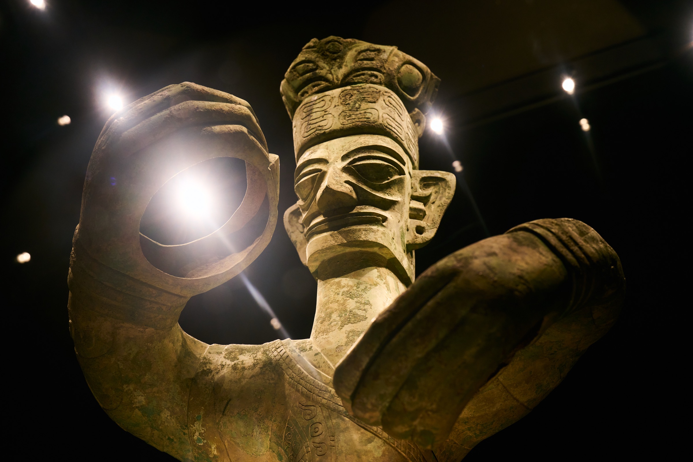 Standing figure's hands seeming to hold a glow of light, Sanxingdui Museum, Guanghan, China