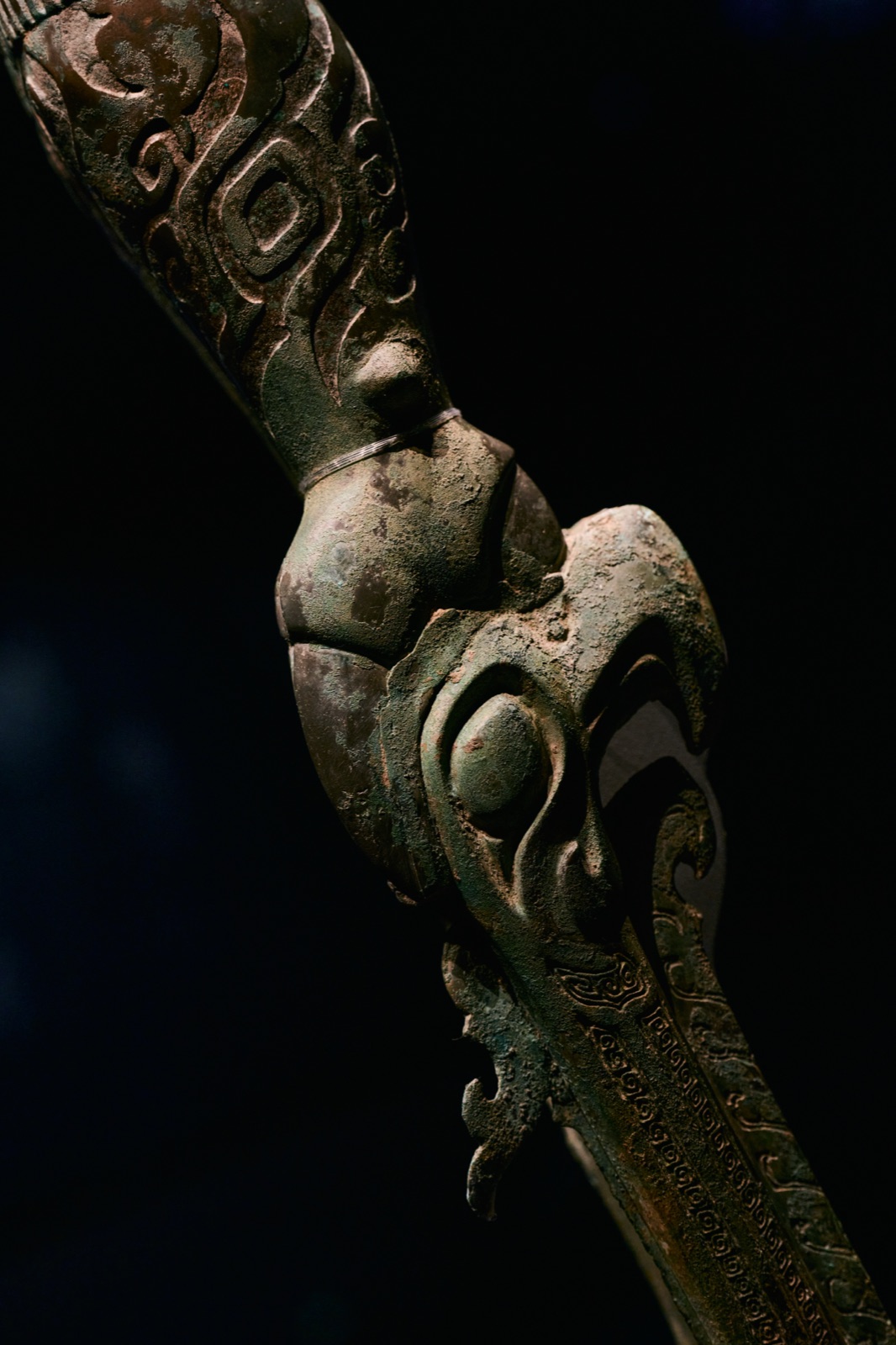Diagonal close-up of an ornate bronze staff fragment, Sanxingdui Museum, Guanghan, China