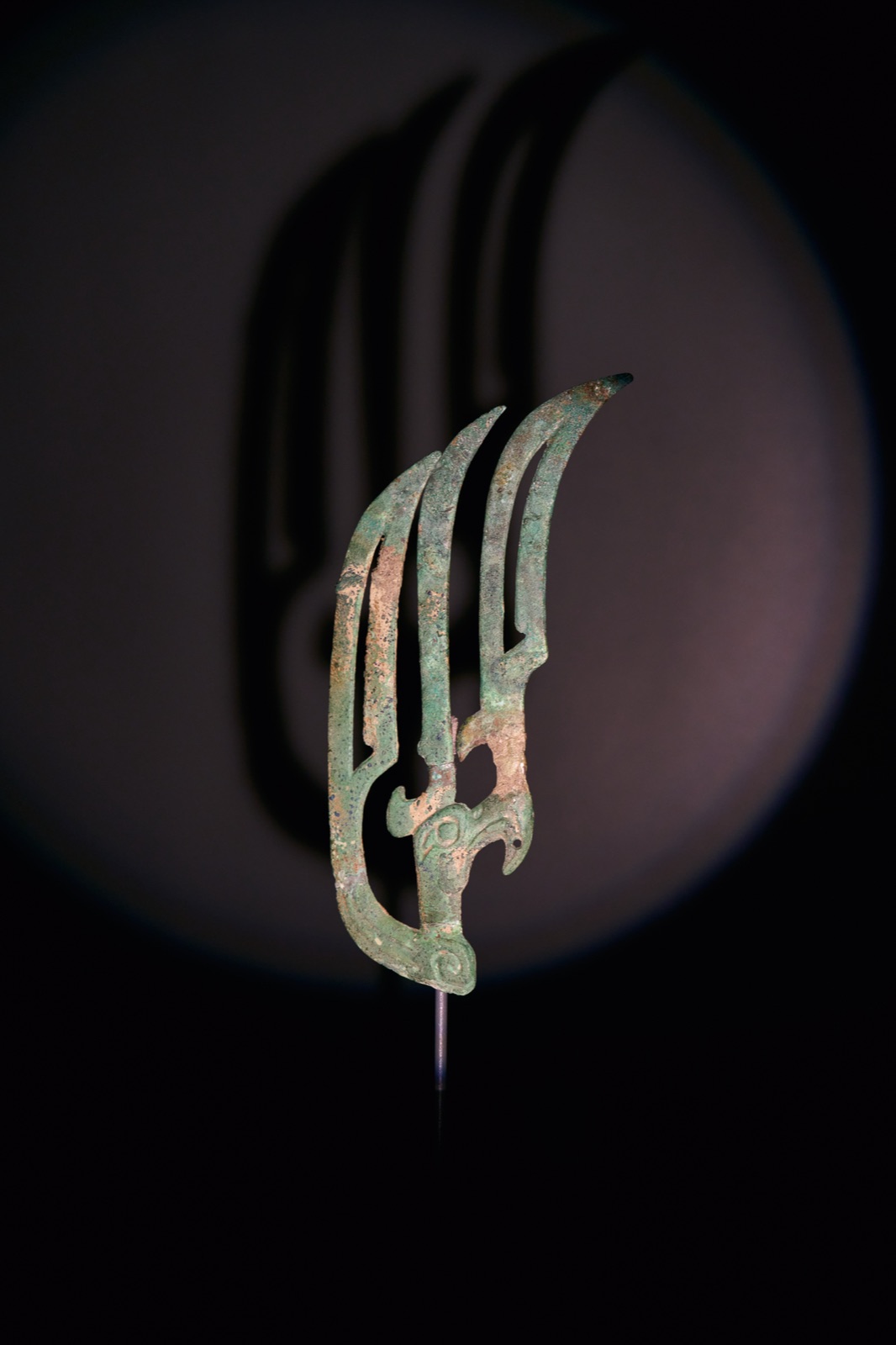 Claw-shaped bronze piece with its enlarged shadow on a lit disc, Sanxingdui Museum, Guanghan, China