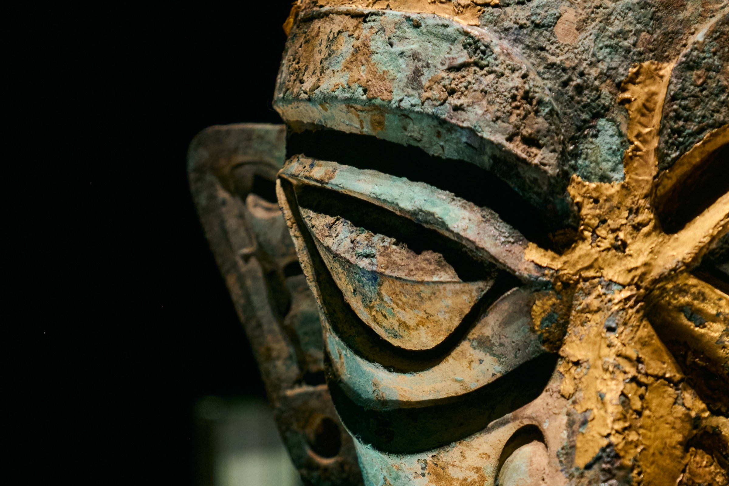 Close-up of a mask's eye with gold-flecked patina, Sanxingdui Museum, Guanghan, China